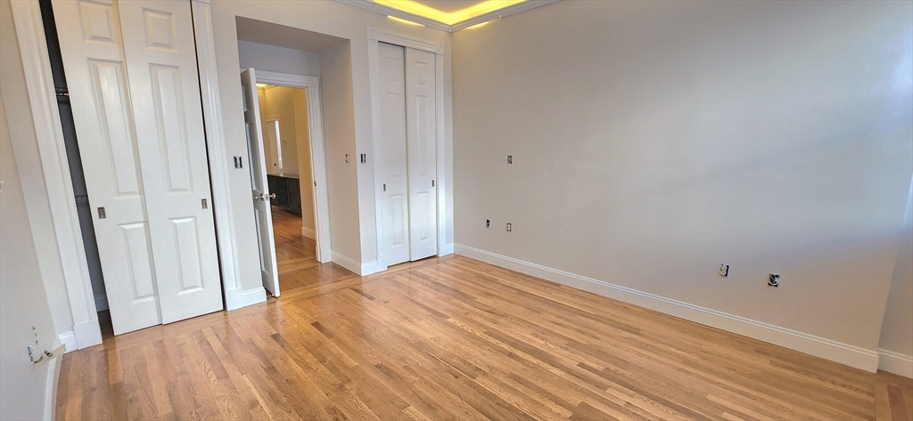 191 Maverick Street, Unit 1L Boston, MA 02128 - Photo 15 of 16 a view of a room with wooden floor