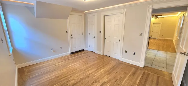 a view of a room with wooden floor