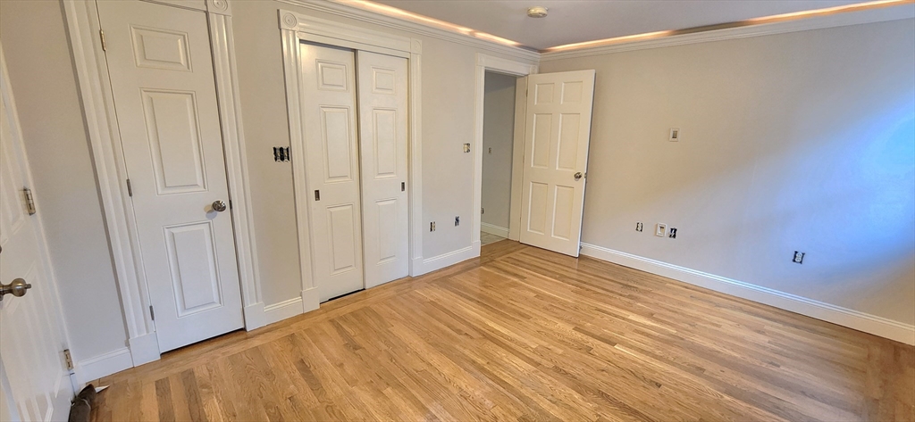 191 Maverick Street, Unit 1L Boston, MA 02128 - Photo 7 of 16 a view of empty room with wooden floor