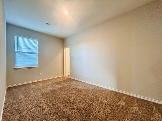 an empty room with a empty space and a window