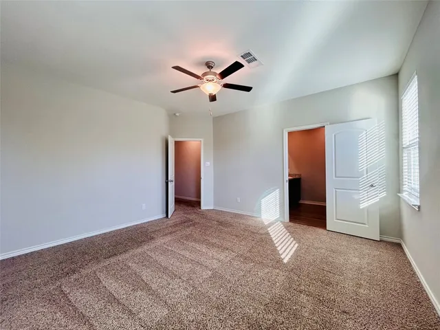 a view of empty room with ceiling fan