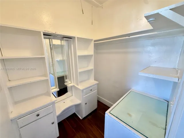 a view of bathroom with a sink and mirror
