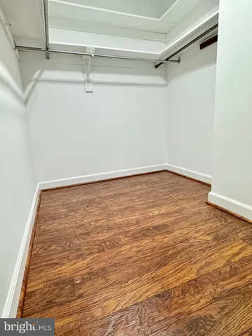 a bathroom with a granite countertop sink a mirror and shower