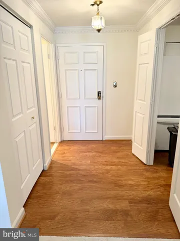 a view of empty room with wooden floor