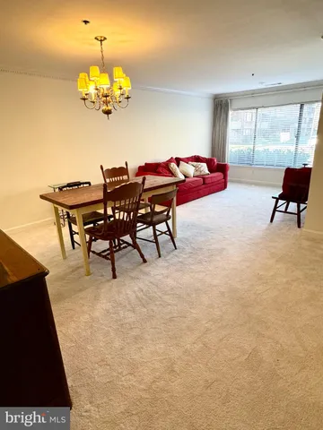 a view of a dining room with furniture and chandelier