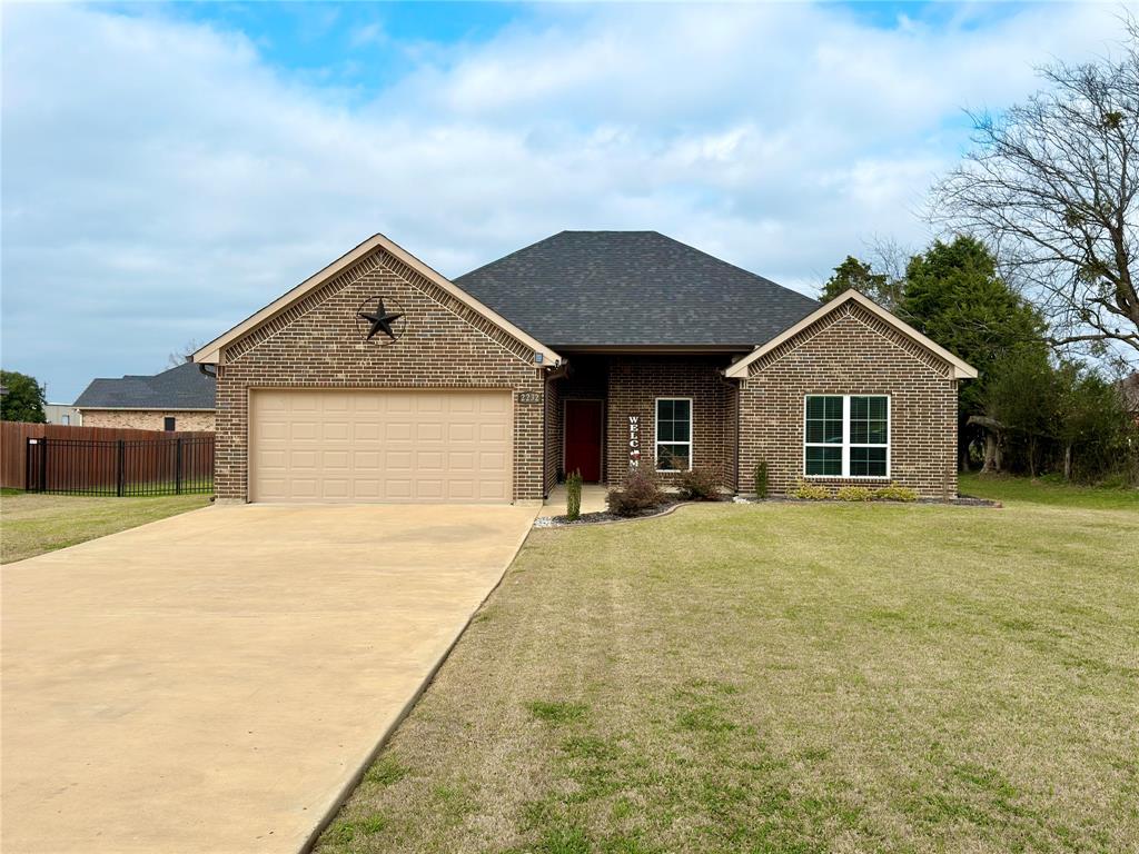 2232 Samuel Street Mabank, TX 75147 - Photo 1 of 36 a front view of a house with a garden