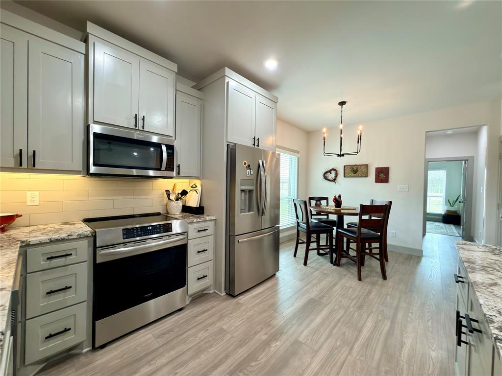 2232 Samuel Street Mabank, TX 75147 - Photo 11 of 36 a kitchen with stainless steel appliances a stove a sink a refrigerator cabinets and a dining table