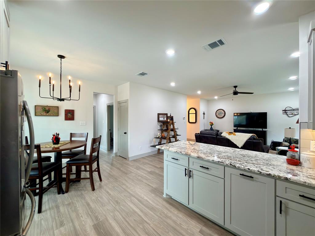 2232 Samuel Street Mabank, TX 75147 - Photo 12 of 36 a kitchen with stainless steel appliances kitchen island granite countertop a sink and cabinets