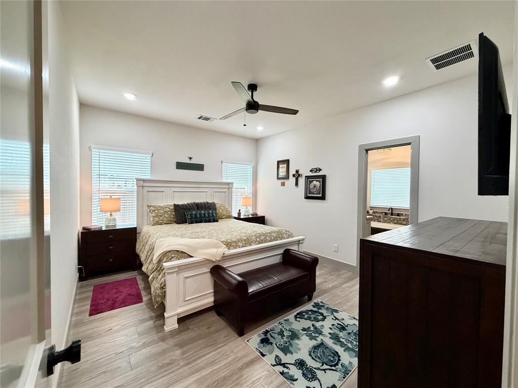 2232 Samuel Street Mabank, TX 75147 - Photo 13 of 36 a bedroom with a bed and a chandelier