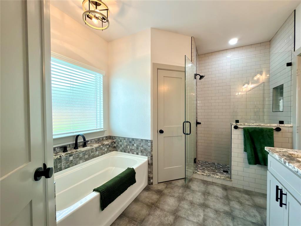 2232 Samuel Street Mabank, TX 75147 - Photo 16 of 36 a spacious bathroom with a tub shower and sink