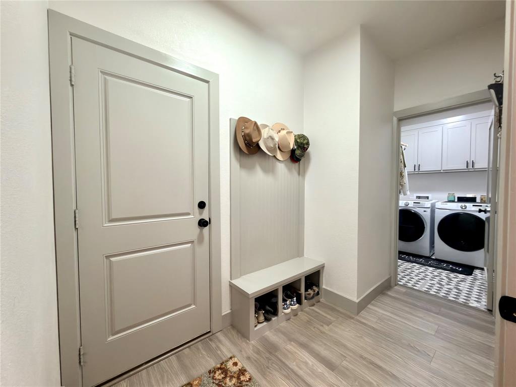 2232 Samuel Street Mabank, TX 75147 - Photo 23 of 36 a view of a hallway and a room with wooden floor