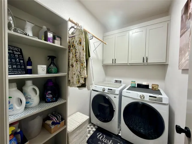 a utility room with sink dryer and washer
