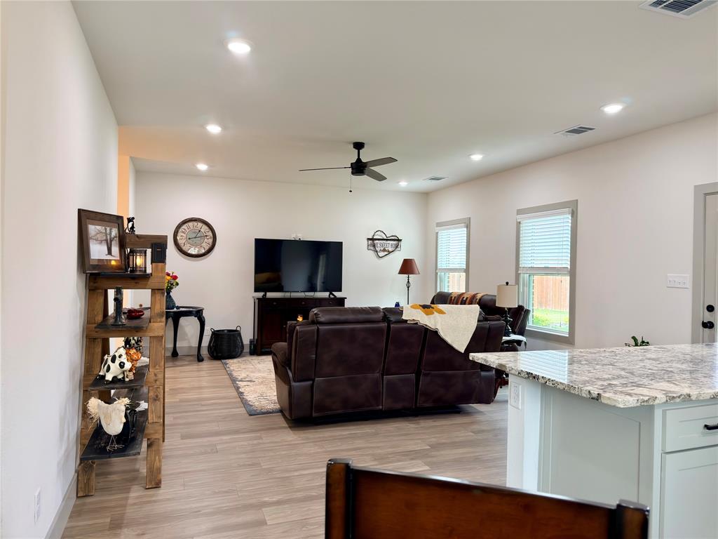 2232 Samuel Street Mabank, TX 75147 - Photo 8 of 36 a living room with furniture kitchen view and a flat screen tv