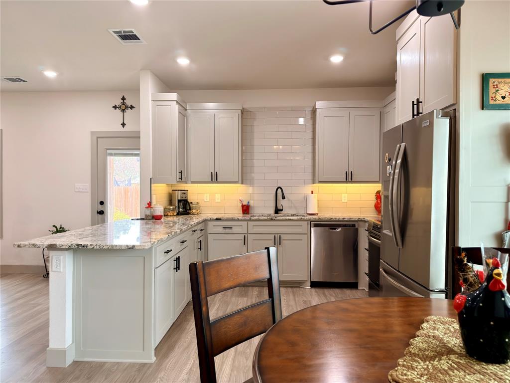2232 Samuel Street Mabank, TX 75147 - Photo 9 of 36 a kitchen with a sink appliances and cabinets