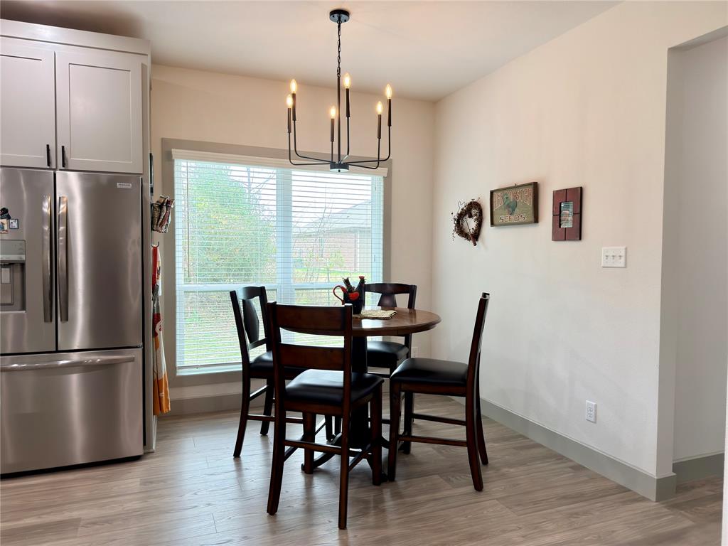 2232 Samuel Street Mabank, TX 75147 - Photo 10 of 36 a dining room with furniture a chandelier and wooden floor