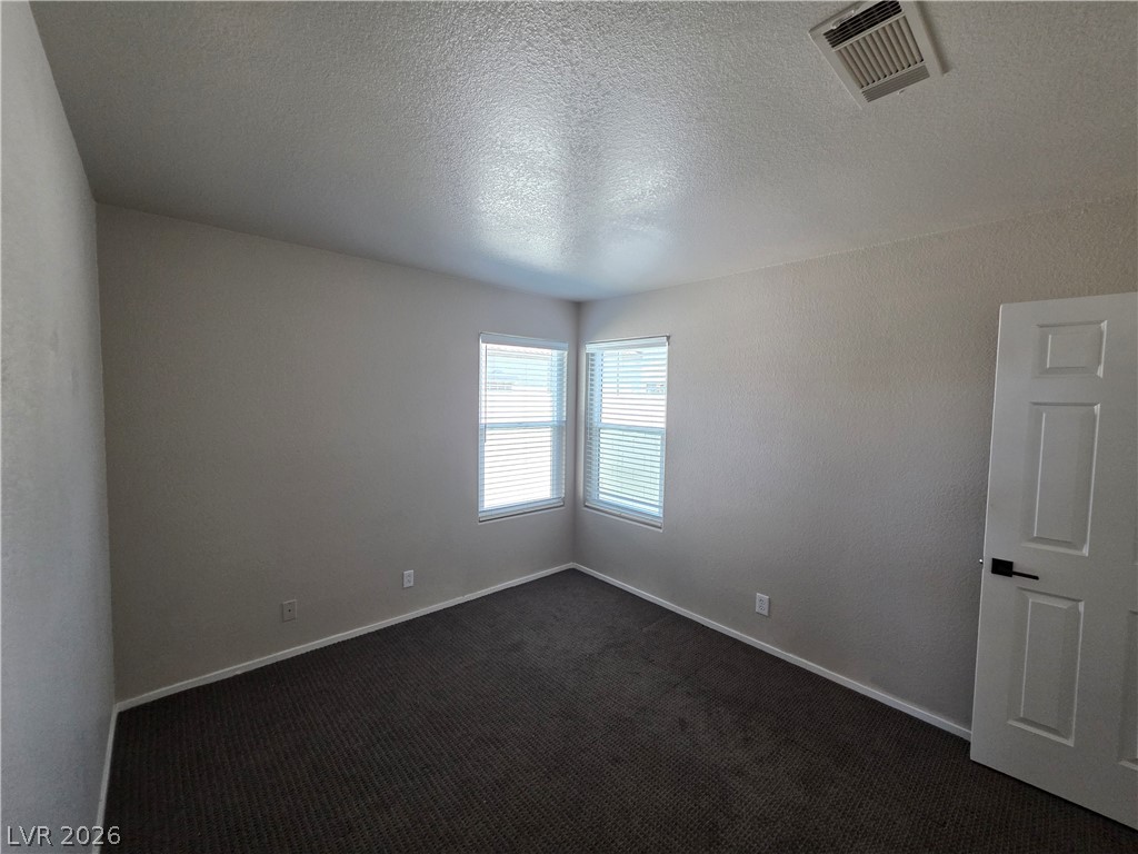 2275 Ramsgate Drive Henderson, NV 89074 - Photo 71 of 84 Two windows allow ample light into this comfortable bedroom, featuring plush carpet flooring.