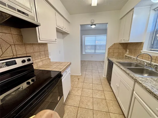 a kitchen with a stove a sink and a microwave