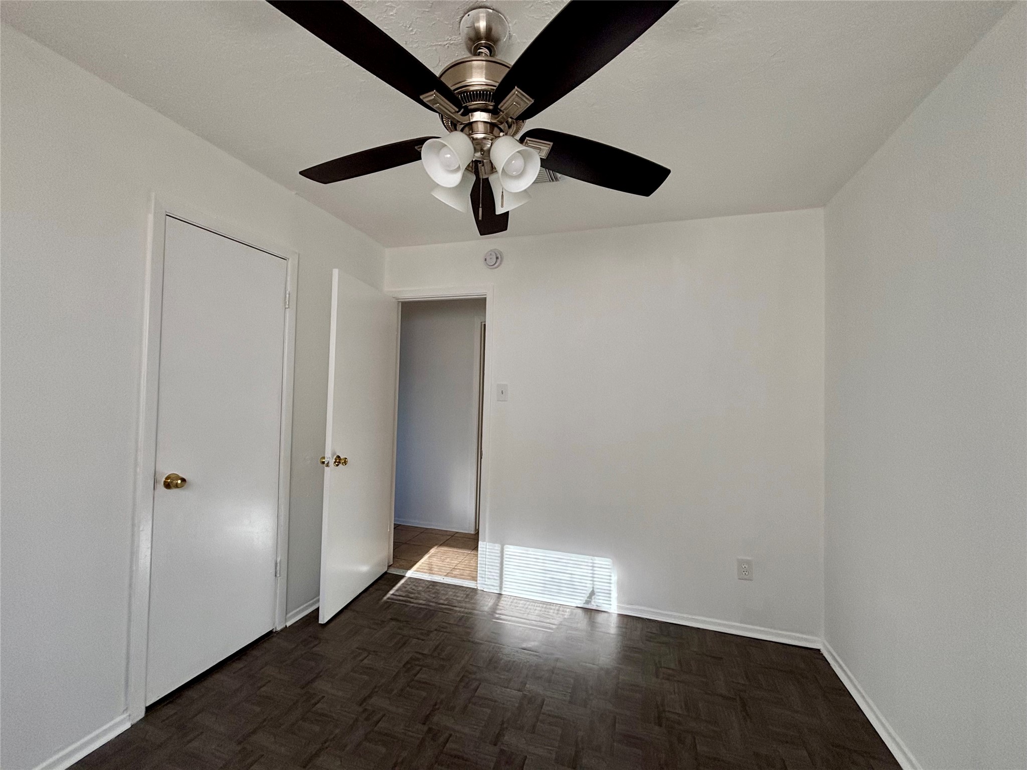 4903 Raven Ridge Drive Houston, TX 77053 - Photo 6 of 20 an empty room with wooden floor closet and ceiling fan