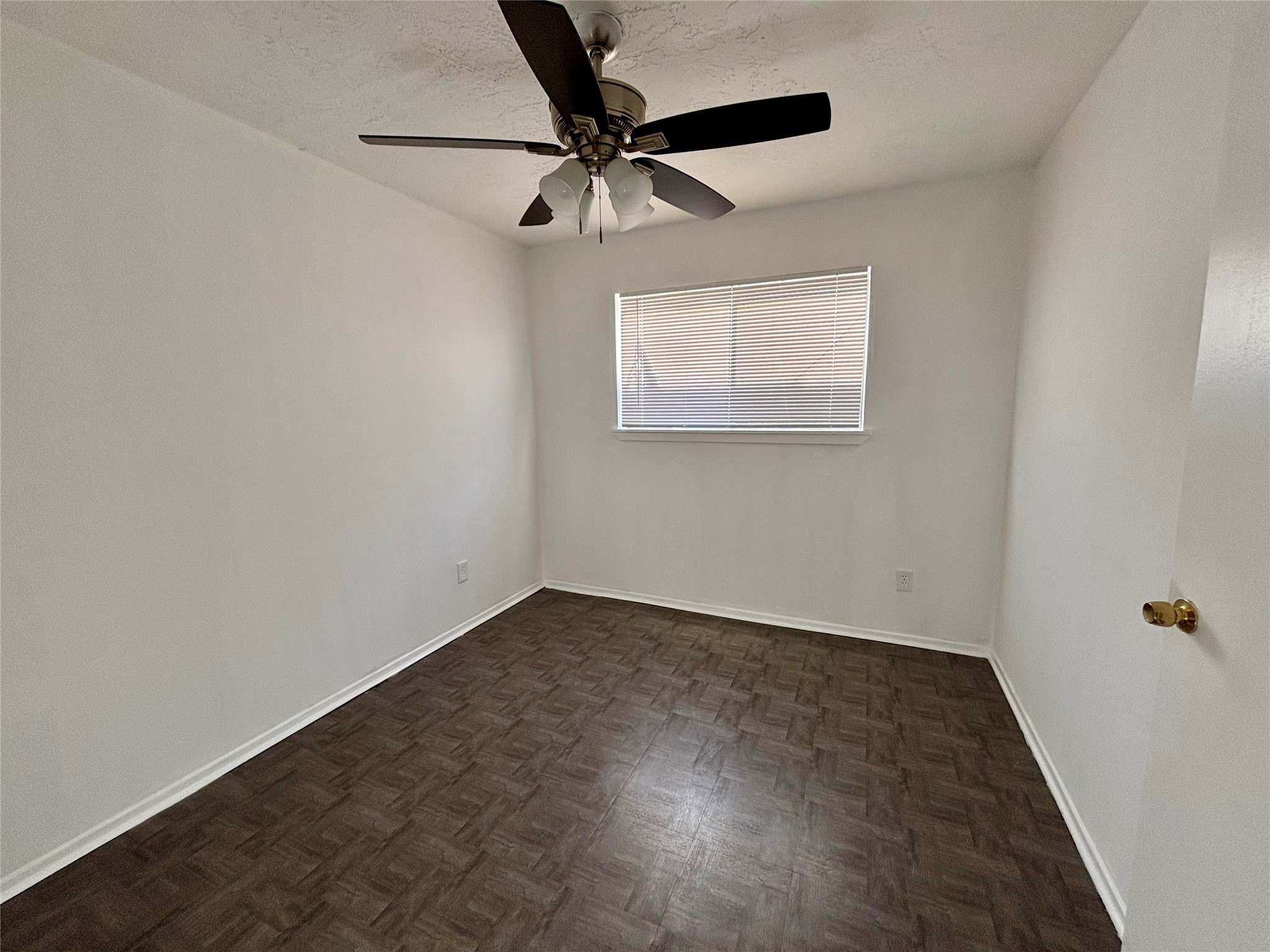 4903 Raven Ridge Drive Houston, TX 77053 - Photo 8 of 20 an empty room with a ceiling fan and wooden floor
