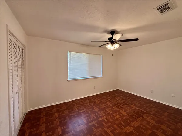 a view of a room with a ceiling fan