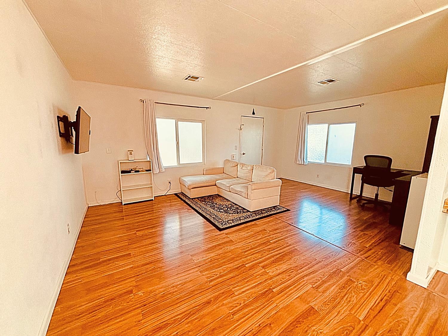 260 West Comet Road Gustine, CA 95322 - Photo 1 of 17 a living room with furniture and a wooden floor