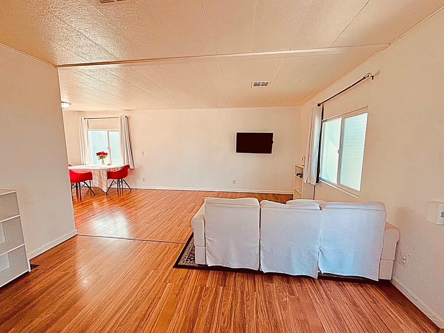 260 West Comet Road Gustine, CA 95322 - Photo 2 of 17 a room with wooden floor and furniture