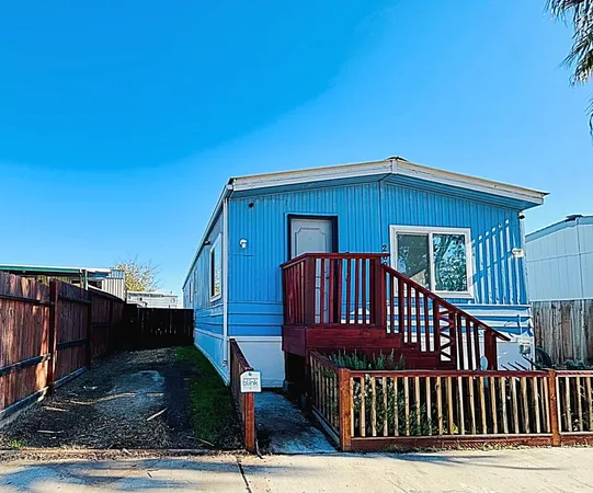 a view of a house with wooden deck