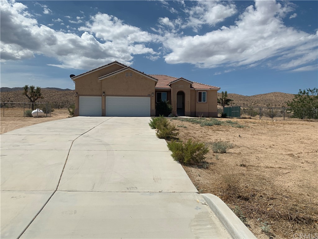 25762 Clark Road Apple Valley, CA 92308 - Photo 1 of 1 a front view of a house with a yard