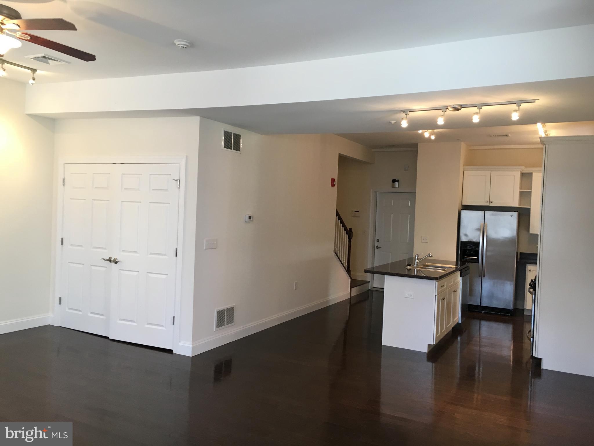 22 North George Street, Unit 1 York, PA 17401 - Photo 7 of 12 a view of kitchen with furniture and wooden floor