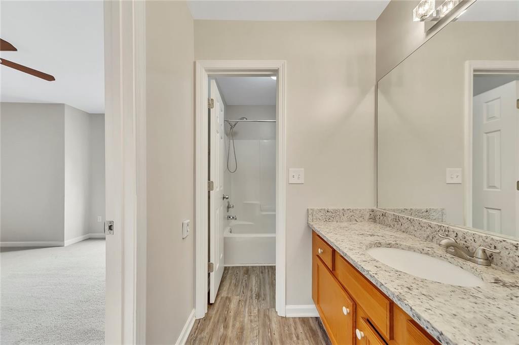 6326 Autumn View Way Northwest Acworth, GA 30101 - Photo 25 of 37 a bathroom with a granite countertop sink and a mirror
