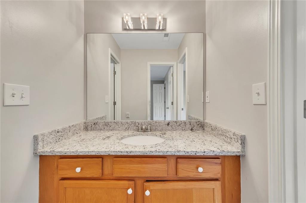 6326 Autumn View Way Northwest Acworth, GA 30101 - Photo 26 of 37 a bathroom with a granite countertop sink and a mirror