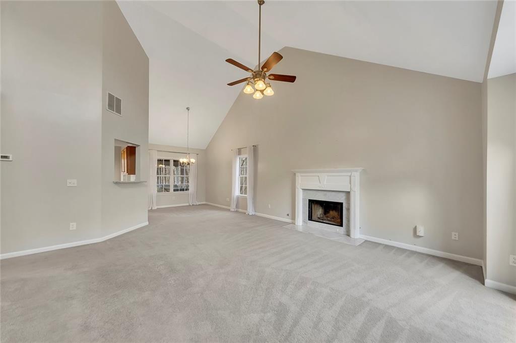 6326 Autumn View Way Northwest Acworth, GA 30101 - Photo 5 of 37 a view of a livingroom with a ceiling fan and fireplace