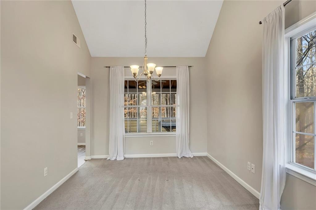 6326 Autumn View Way Northwest Acworth, GA 30101 - Photo 9 of 37 an empty room with chandelier fan and windows