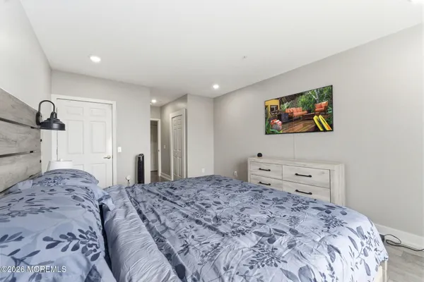 a bedroom with a bed and a painting on the wall
