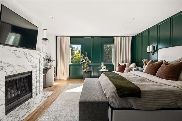 a spacious bedroom with a bed and a dresser