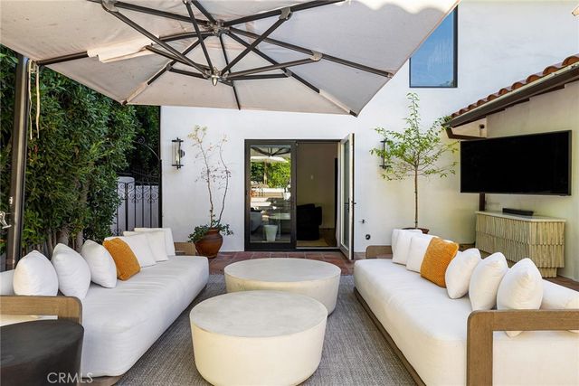 a view of a swimming pool with lawn chairs under an umbrella