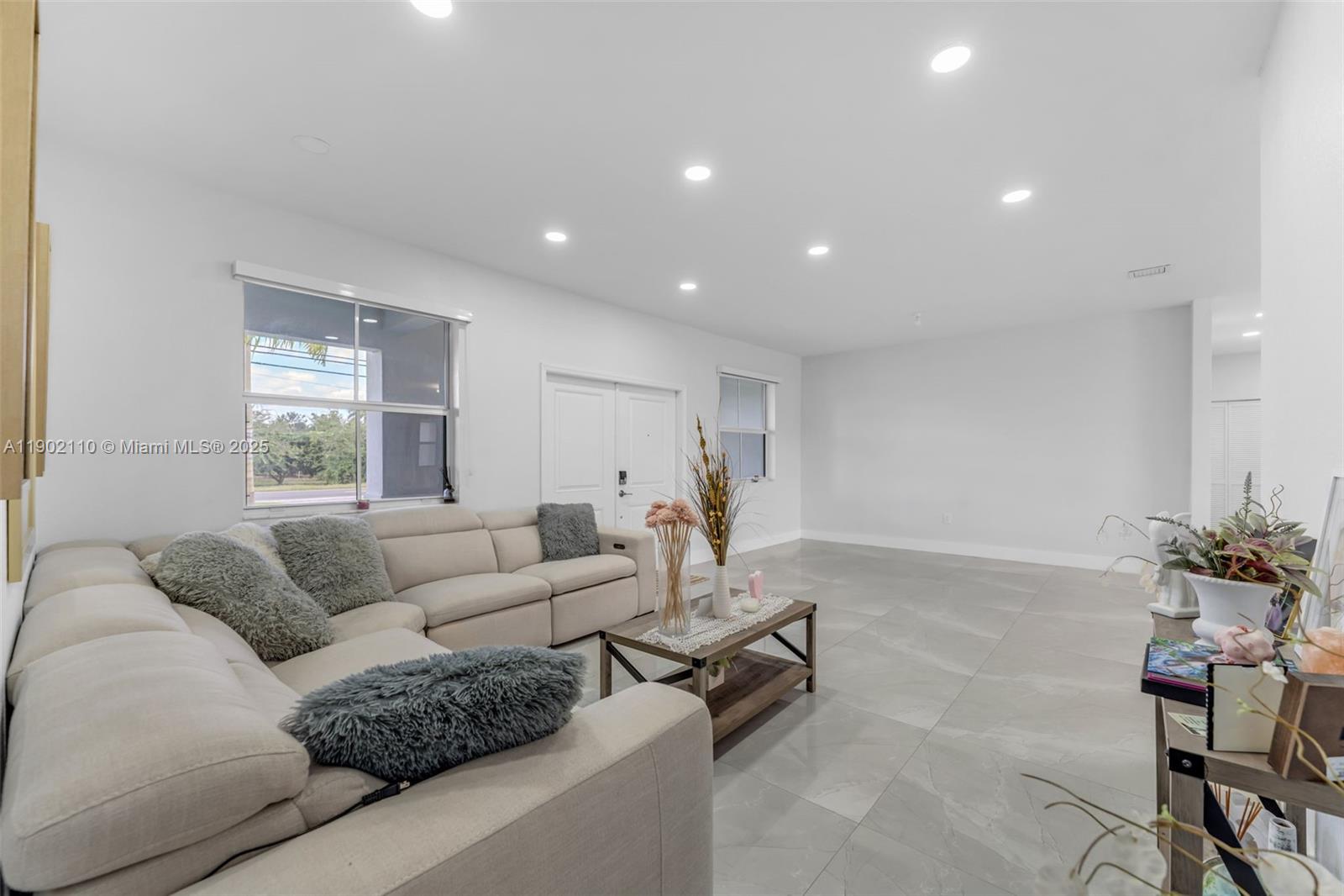 19866 Southwest 320th Street Homestead, FL 33030 - Photo 14 of 55 a living room with furniture and a large window
