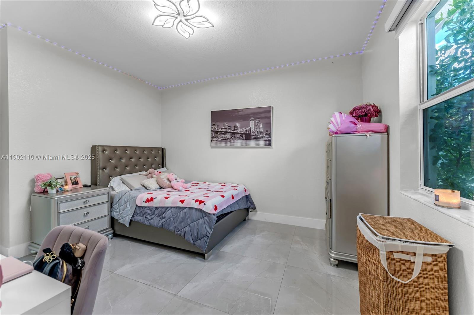 19866 Southwest 320th Street Homestead, FL 33030 - Photo 18 of 55 a bedroom with a bed and a chandelier