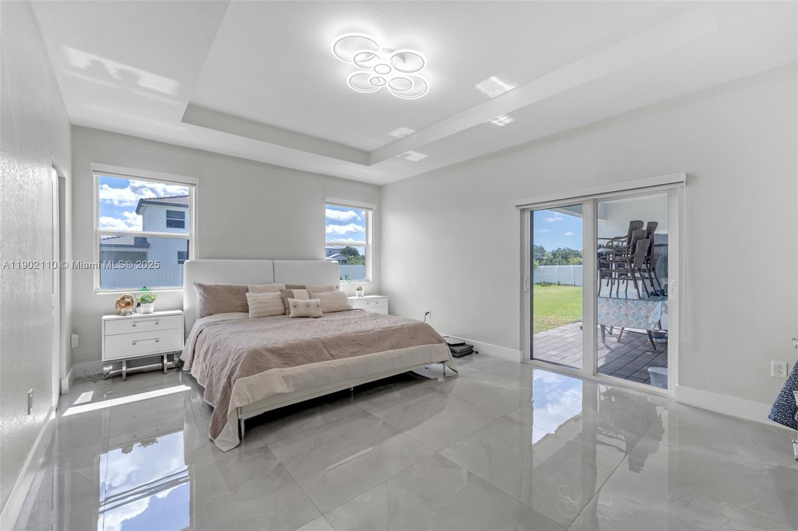19866 Southwest 320th Street Homestead, FL 33030 - Photo 20 of 55 a spacious bedroom with a bed couch and a window