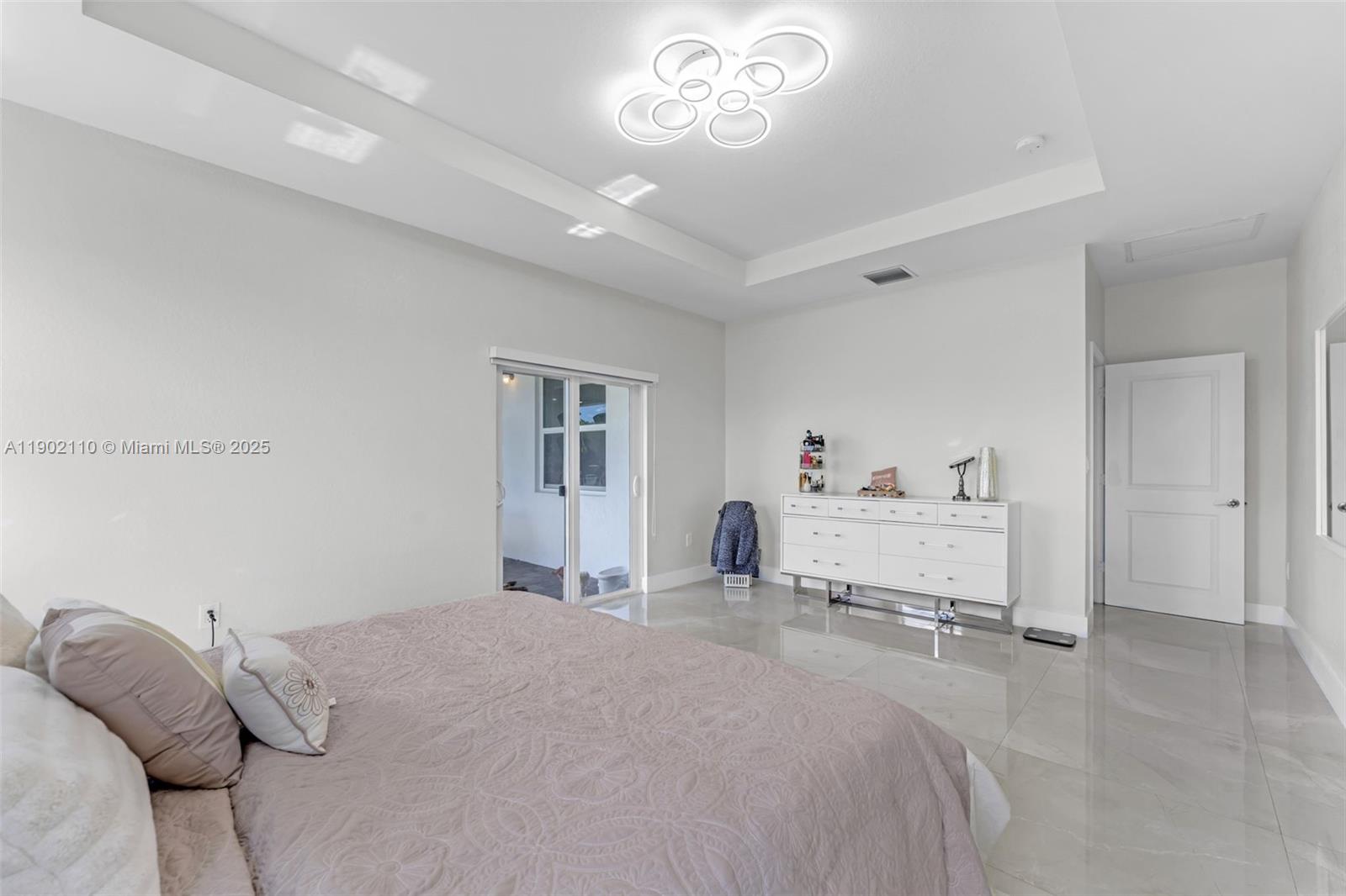 19866 Southwest 320th Street Homestead, FL 33030 - Photo 23 of 55 a bedroom with a bed and a dresser