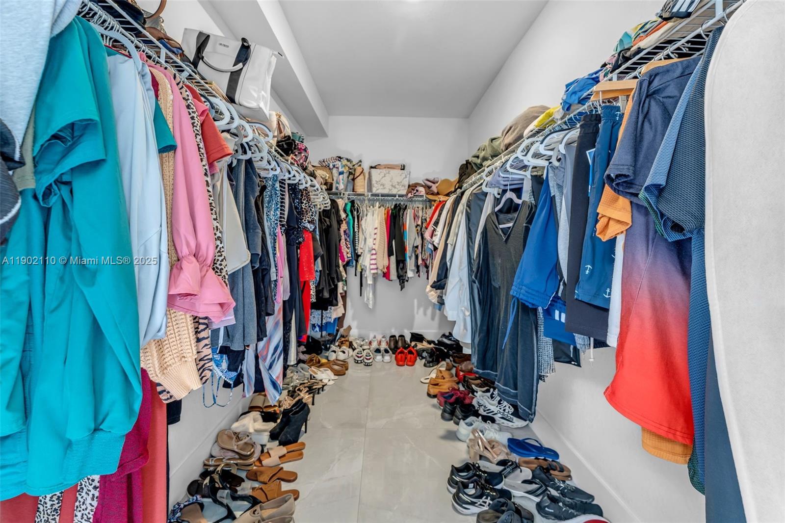 19866 Southwest 320th Street Homestead, FL 33030 - Photo 24 of 55 a view of walk in closet with clothes