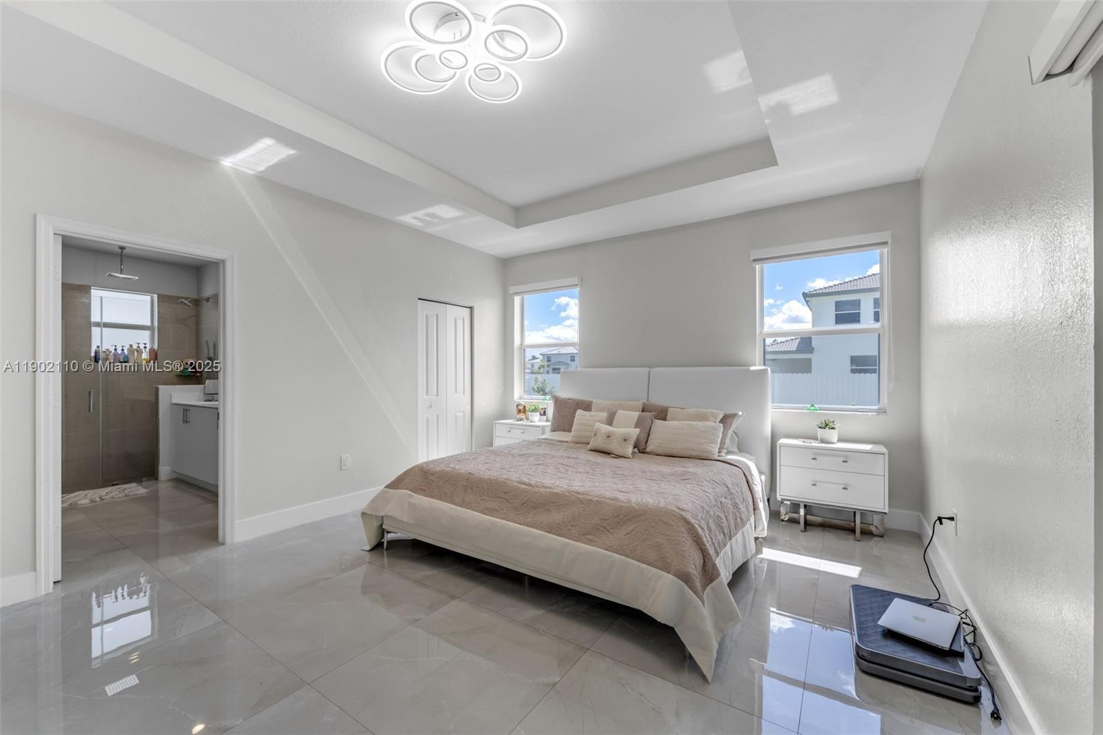 19866 Southwest 320th Street Homestead, FL 33030 - Photo 25 of 55 a bedroom with a bed and a chandelier