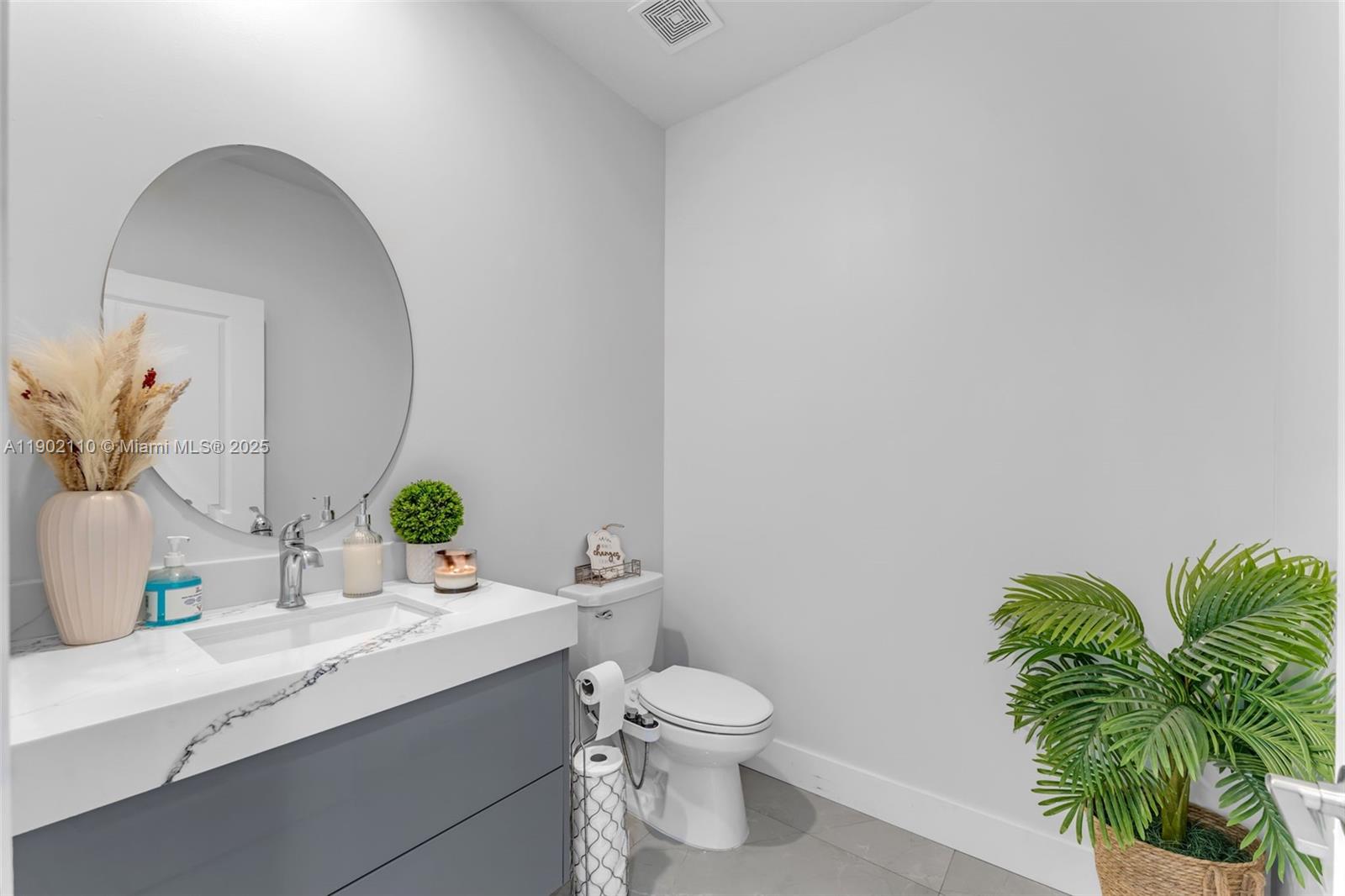 19866 Southwest 320th Street Homestead, FL 33030 - Photo 28 of 55 a bathroom with a toilet sink and mirror