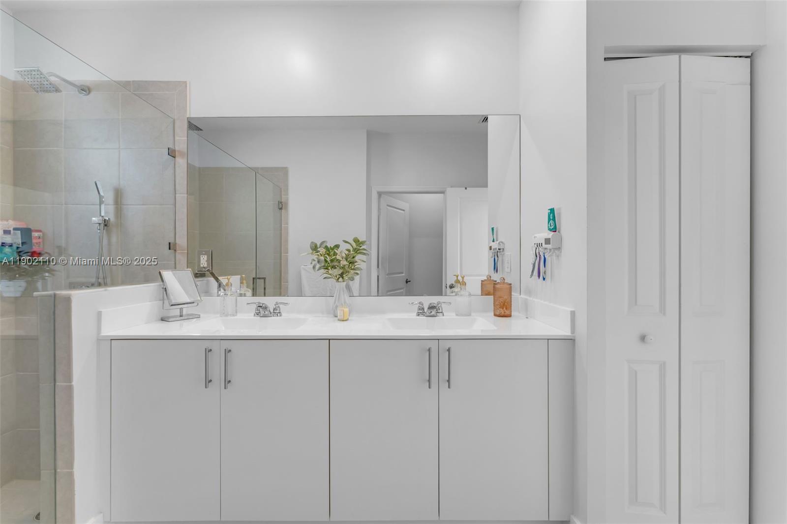 19866 Southwest 320th Street Homestead, FL 33030 - Photo 29 of 55 a bathroom with double sink and a mirror