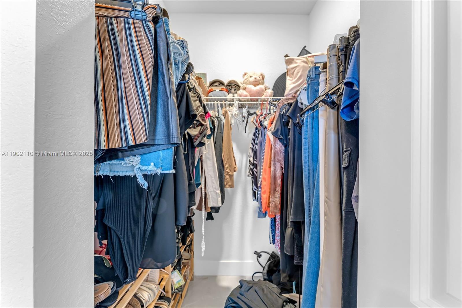 19866 Southwest 320th Street Homestead, FL 33030 - Photo 33 of 55 a view of walk in closet with clothes and shoes
