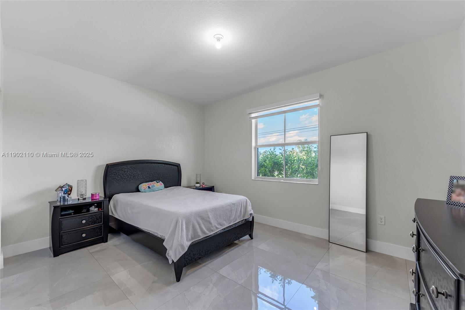 19866 Southwest 320th Street Homestead, FL 33030 - Photo 34 of 55 a bedroom with a bed and a window