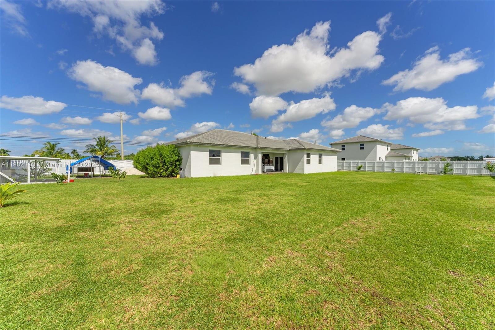 19866 Southwest 320th Street Homestead, FL 33030 - Photo 37 of 55 a view of a house with a yard