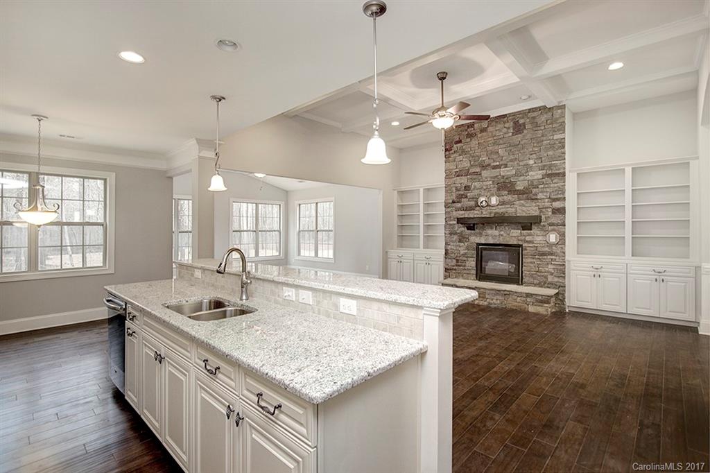 4933 River Oaks Road, Unit 113 Clover, SC 29710 - Photo 3 of 24 a kitchen with kitchen island granite countertop a stove and a sink