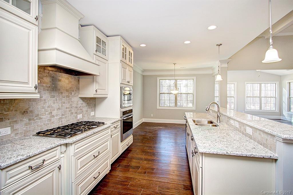 4933 River Oaks Road, Unit 113 Clover, SC 29710 - Photo 4 of 24 a large kitchen with stainless steel appliances granite countertop a lot of counter space and wooden floors