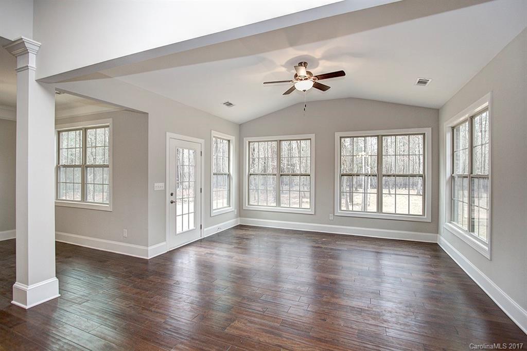 4933 River Oaks Road, Unit 113 Clover, SC 29710 - Photo 8 of 24 a view of an empty room with wooden floor and a window